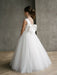 Teter Warm Shelly Satin Bow Communion Dress shown on a girl standing indoors with a large white bow