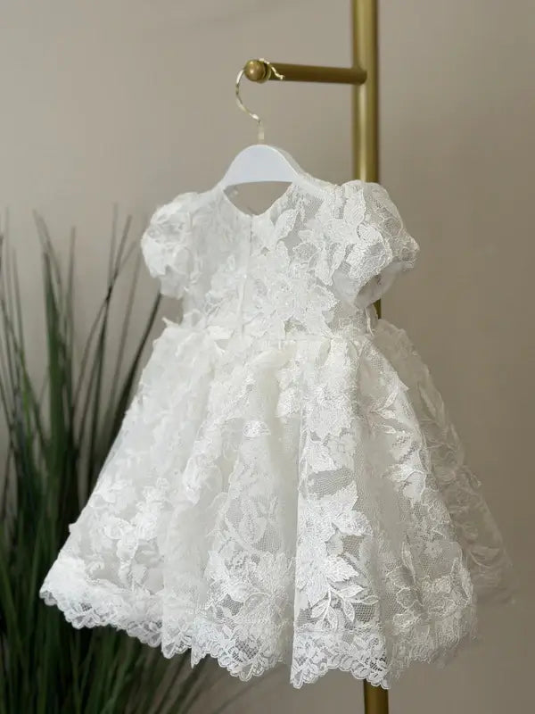 Teter Warm Sia Off-White Floral Baptism Dress displayed on a hanger with lace details.