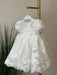 Teter Warm Sia Off-White Floral Baptism Dress displayed on a hanger with lace details.