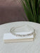 Teter Warm Solver Teardrop Headpiece with clear crystals displayed on a white box on a fabric surface.