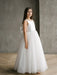 Sylvia Satin Pearl Communion Dress shown on a young girl standing indoors on wood floor