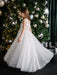Teter Warm Thea off-white communion dress shown on a girl standing by a decorated Christmas tree.