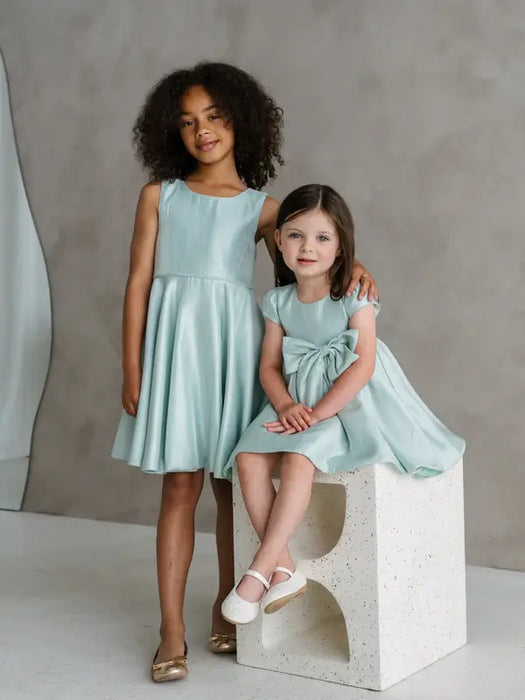 Teter Warm Tiffany Blue Sleeveless Party Dress modeled by two young girls in a studio setting.