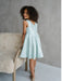 Teter Warm Tiffany Blue sleeveless party dress worn by a girl standing beside a chair indoors.