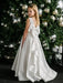Teter Warm Tori off-white lace communion dress shown on a young girl in front of a decorated tree.