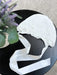 Teter Warm Ultra Soft Baby Bonnet with lace detail displayed on a black table beside a plant.