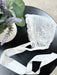 Teter Warm vintage baby bonnet with white lace and ribbon displayed on a round black table.