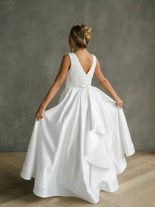 Teter Warm Yasmin off white communion dress shown on a girl from the back in a studio setting.