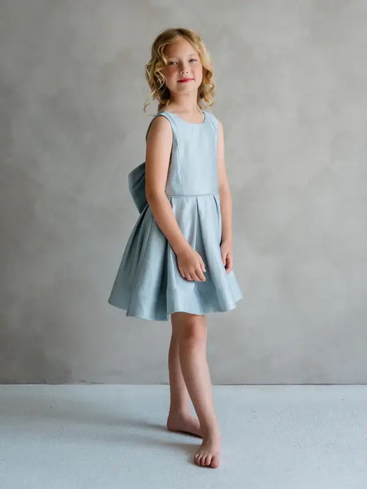 Teter Warm Zelda blue party dress shown on a young girl standing against a neutral backdrop.
