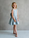 Teter Warm Zelda blue party dress shown on a young girl standing against a neutral backdrop.
