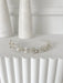 Lydia rhinestone and pearl headpiece displayed on a white fluted surface with a minimalist background.