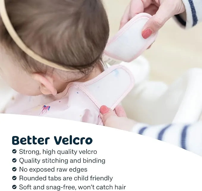 Tiny Twinkle water and mess proof bib being fastened on a baby with soft velcro closure.