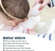 Tiny Twinkle water and mess proof bib being fastened on a baby with soft velcro closure.