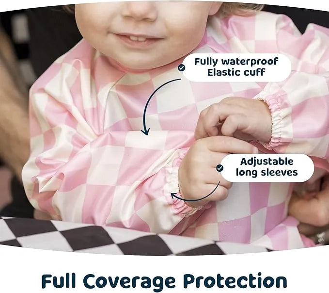 Tiny Twinkle Water Mess Proof Bib with pink check pattern shown on a child, highlighting waterproof fabric and adjustable sleeves.