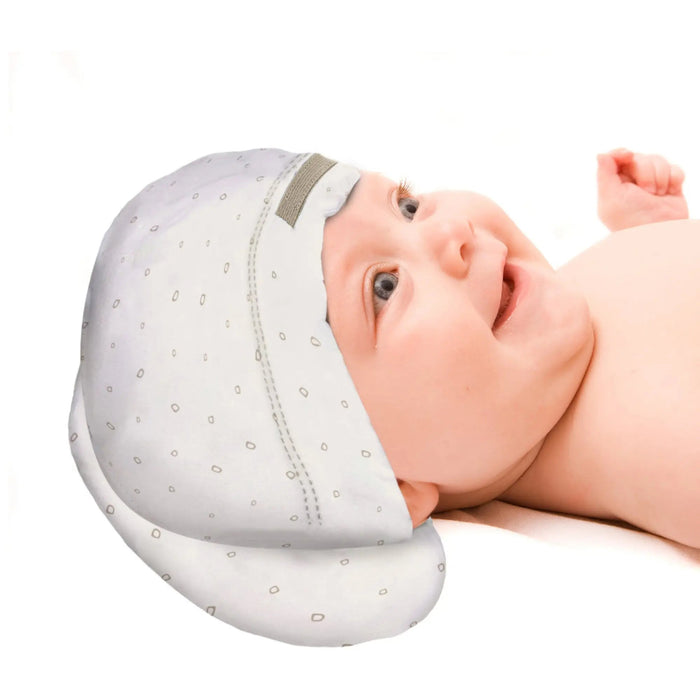 Baby wearing Tortle Air Turtle Trot corrective beanie
