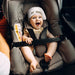 Baby in car seat wearing Tortle Air Turtle Trot repositioning beanie