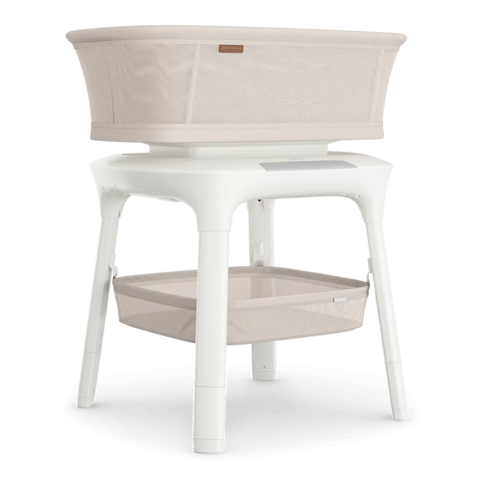 Modern beige bassinet with mesh sides and white frame, baby sleeping furniture