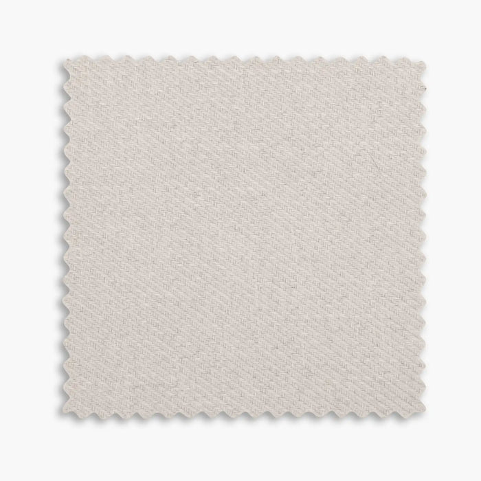 Beige woven fabric swatch sample with zigzag trimmed edges on white background