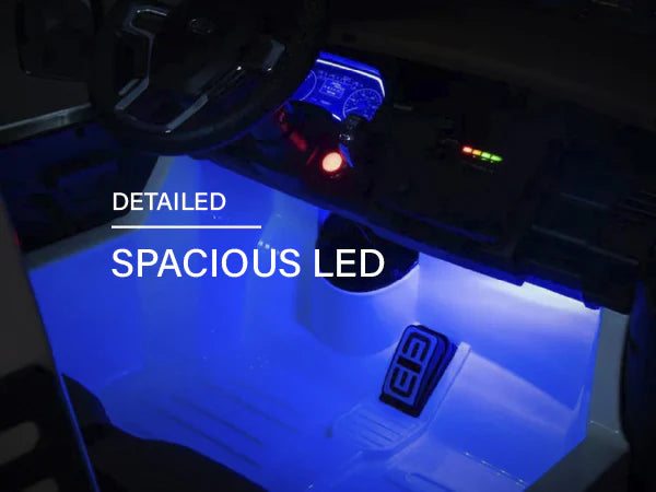 Voltz Toys F-450 ride-on car interior with spacious blue LED lighting and dashboard view.
