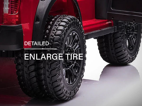Voltz Toys F-450 lifted ride-on car showing close-up of large detailed rear tires on a white floor.