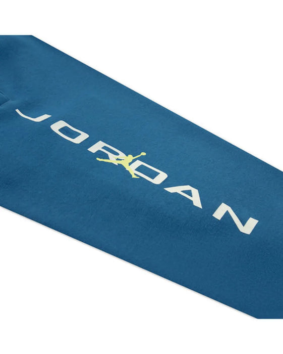 Blue Jordan kids' sweatshirt sleeve with white logo and yellow graphic on fabric.
