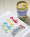 Jack N' Jill Fairy Floss dental floss 30 pack with colorful giraffe flossers on a white towel.