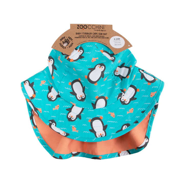 ZOOCCHINI baby and toddler cape sun hat with penguin and fish print shown on white background.