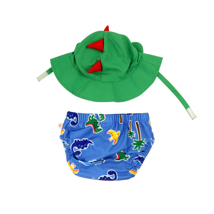 Zoocchini swim diaper set with green dinosaur hat and blue dinosaur print bottoms on white background.