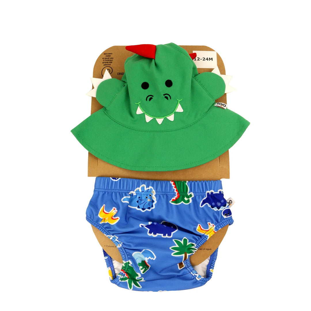 Zoocchini swim diaper set with green dinosaur sun hat and blue dinosaur print swim bottoms on package.